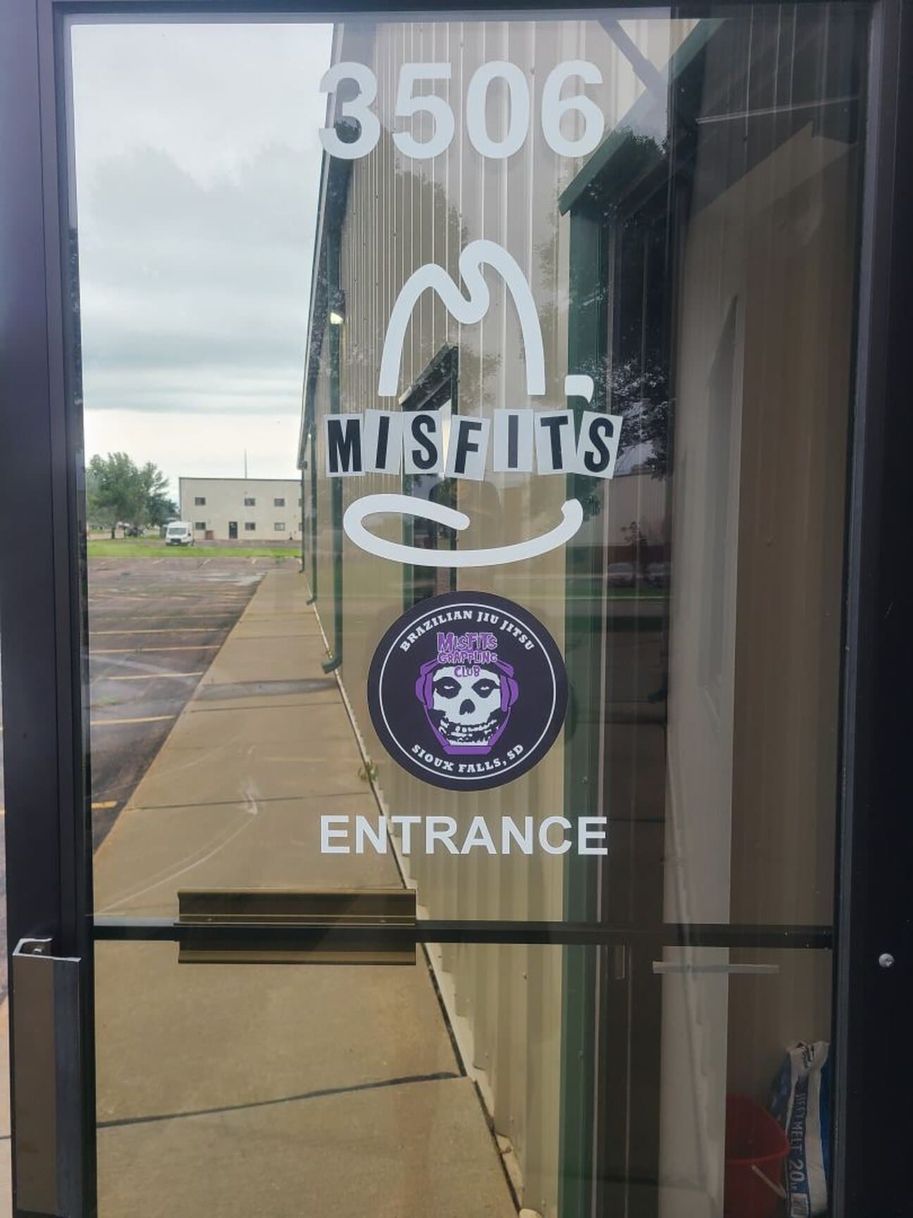The Misfits Grappling Club entrance at 3506, with the skull crest on the glass