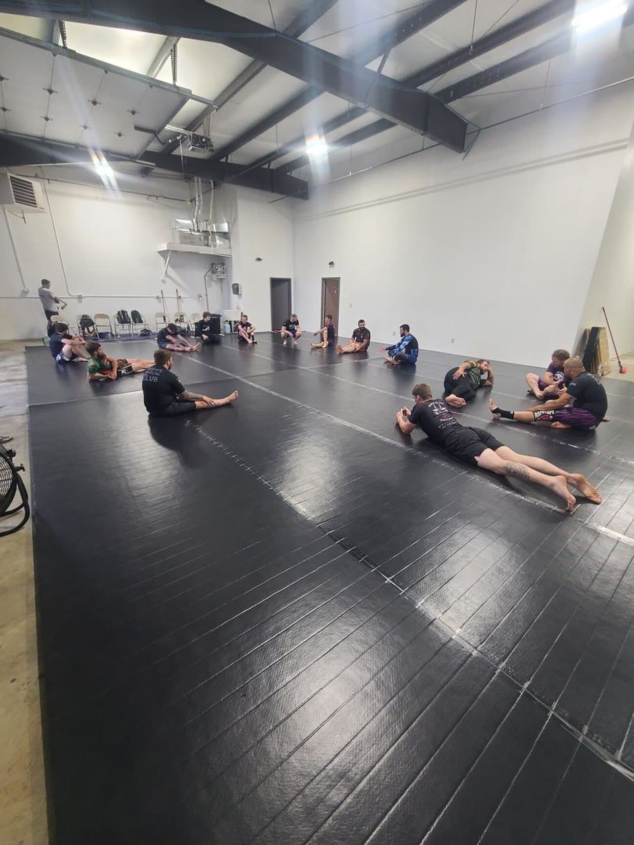 The Misfits mat room, a class seated in a circle before rounds