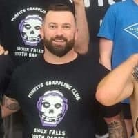 Tyler Ockenga in a Misfits Grappling Club shirt