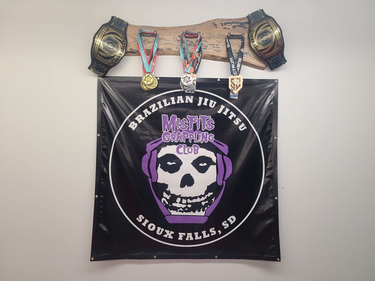 Championship belts and Submission Challenge medals hung over the Misfits banner