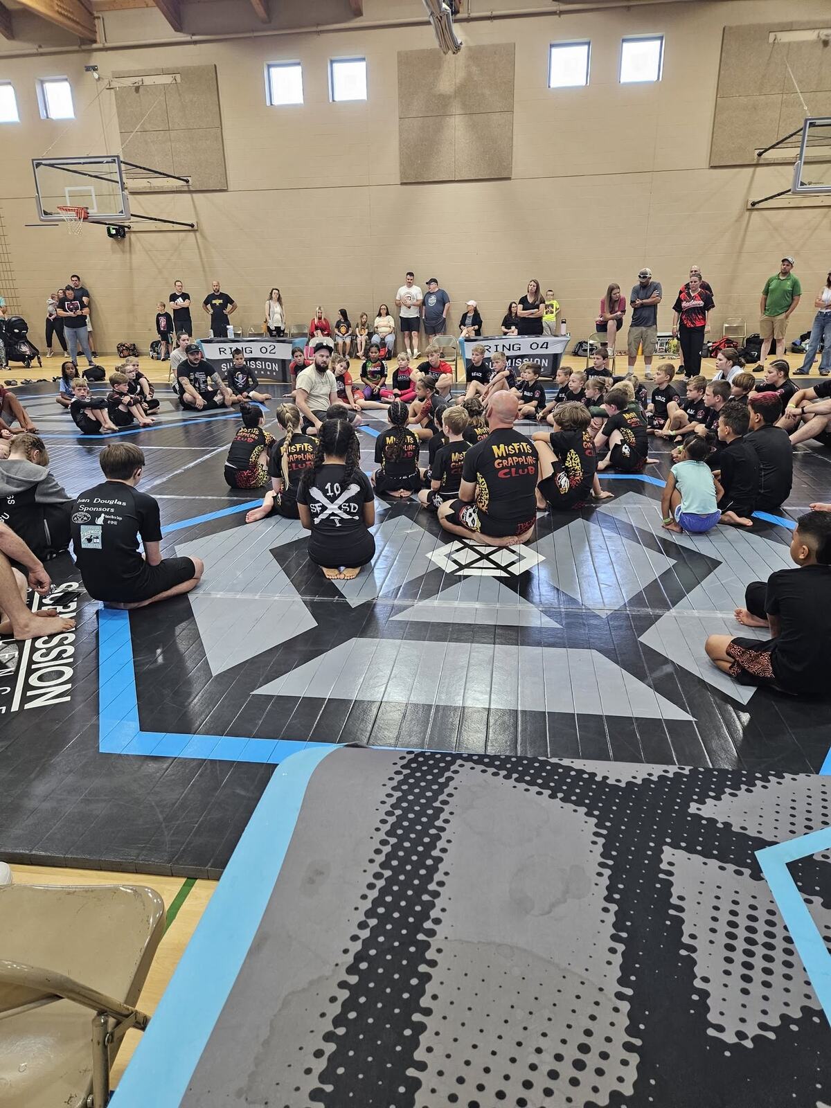 The Misfits kids and coaches circled up on the mats before the Submission Challenge