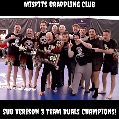 The Misfits team holding the Sub-Version 3 team duals championship trophy